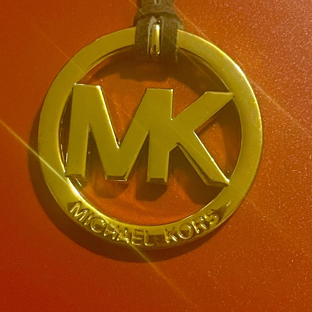 Michael Kors Gold tone bag charm with MK Design. EUC.